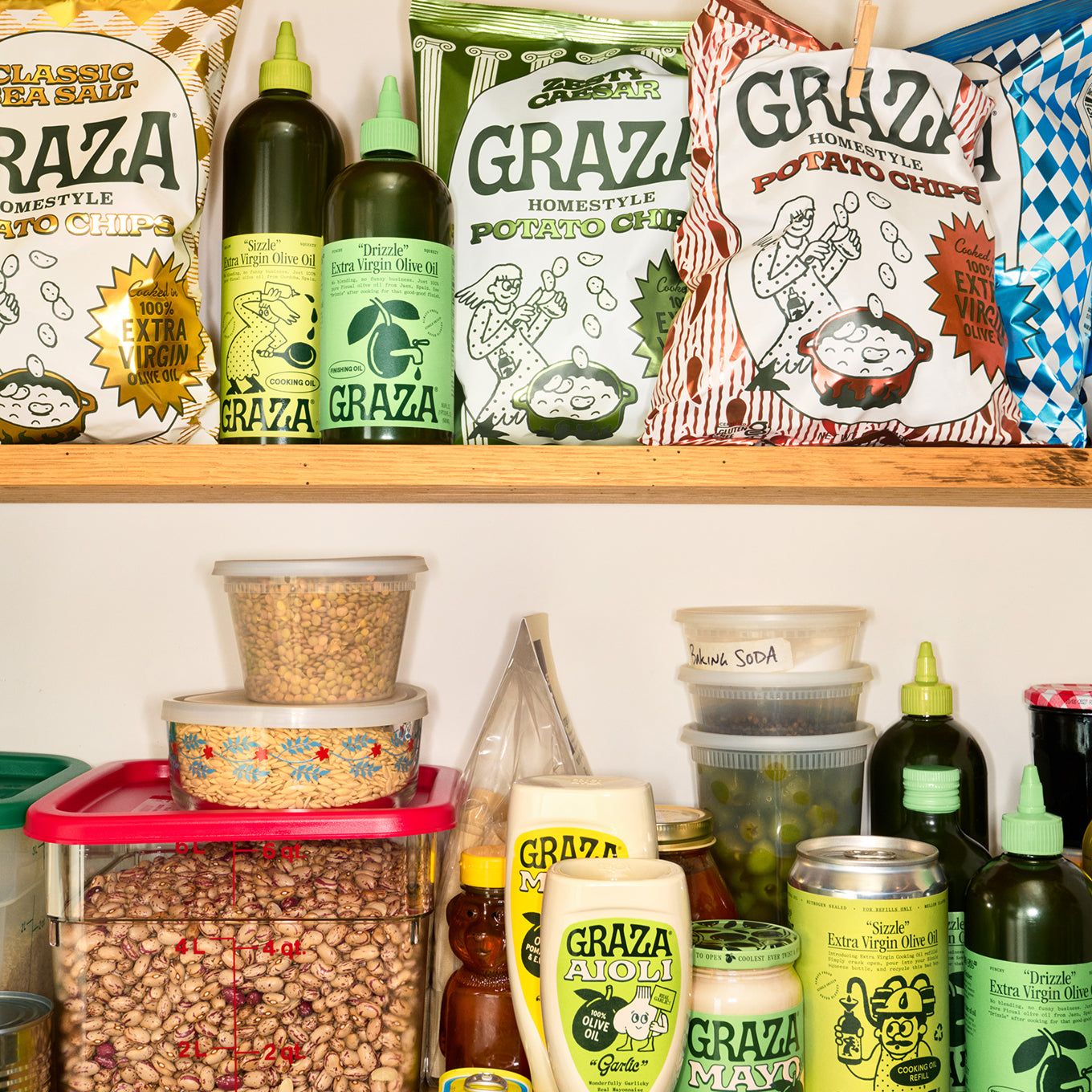 A pantry shelf stocked with Graza bottles and cans