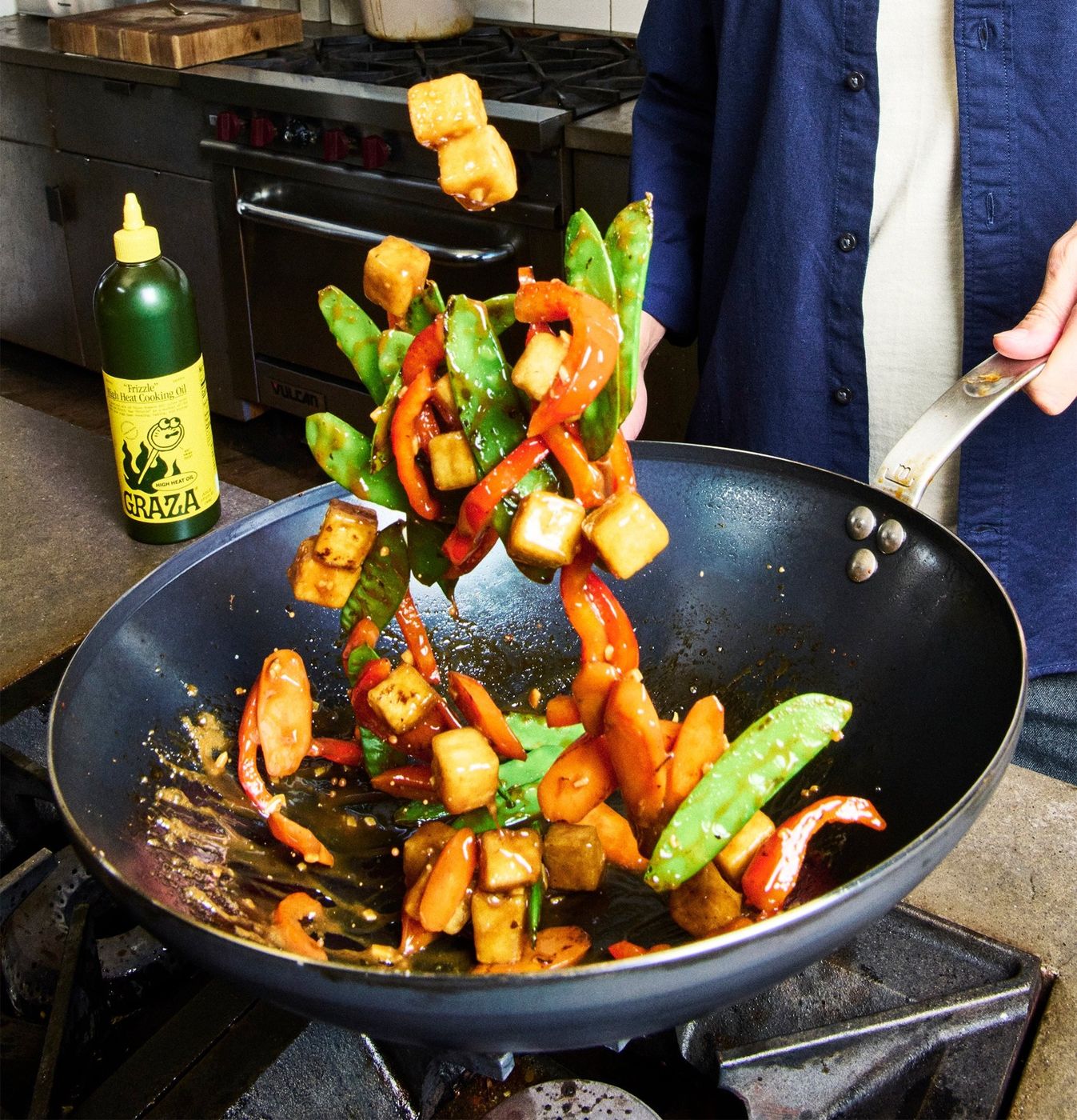 Vegetables tossed in a wok cooked with “Sizzle”